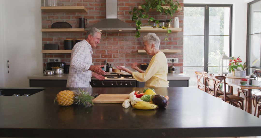 Smiling Senior Couple Cooking Together in Modern Home Kitchen - Free Images, Stock Photos and Pictures on Pikwizard.com