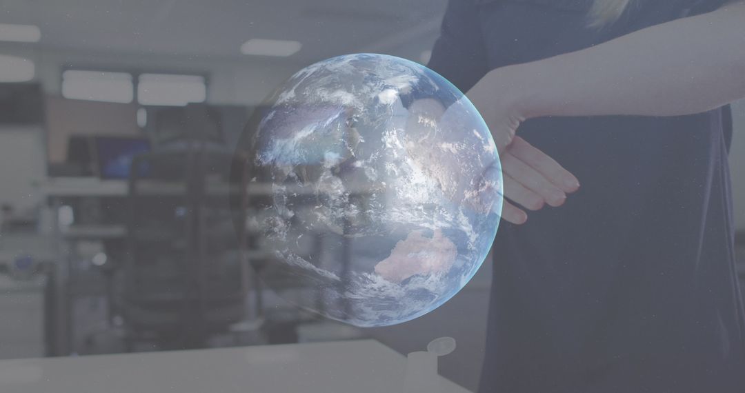 Woman Disinfecting Hands with Holographic Globe in Office