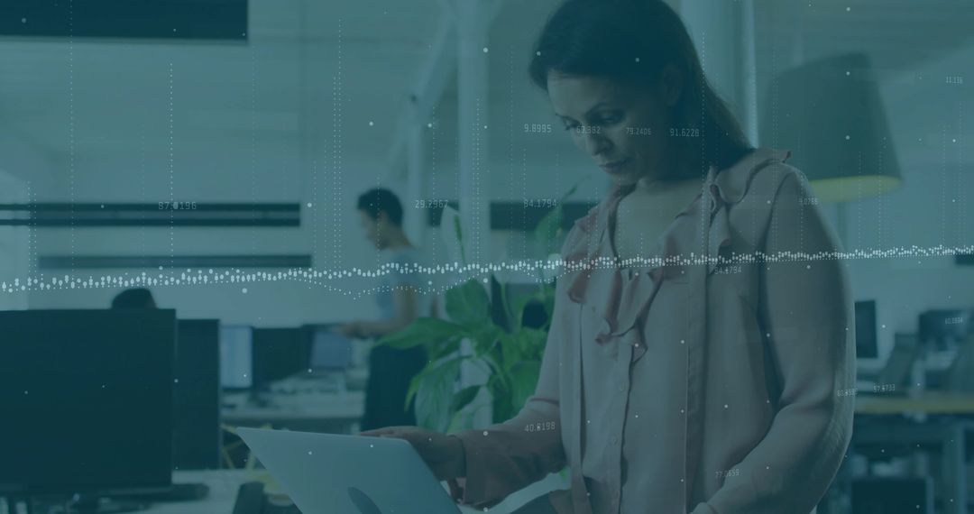Professional Woman Using Laptop in Modern Open-Plan Office with Plants
