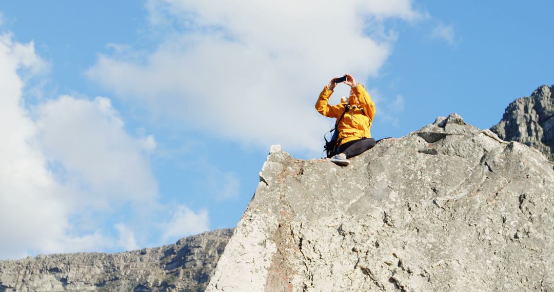 Woman Takes Photo on Rocky Mountain Peak - Free Images, Stock Photos and Pictures on Pikwizard.com