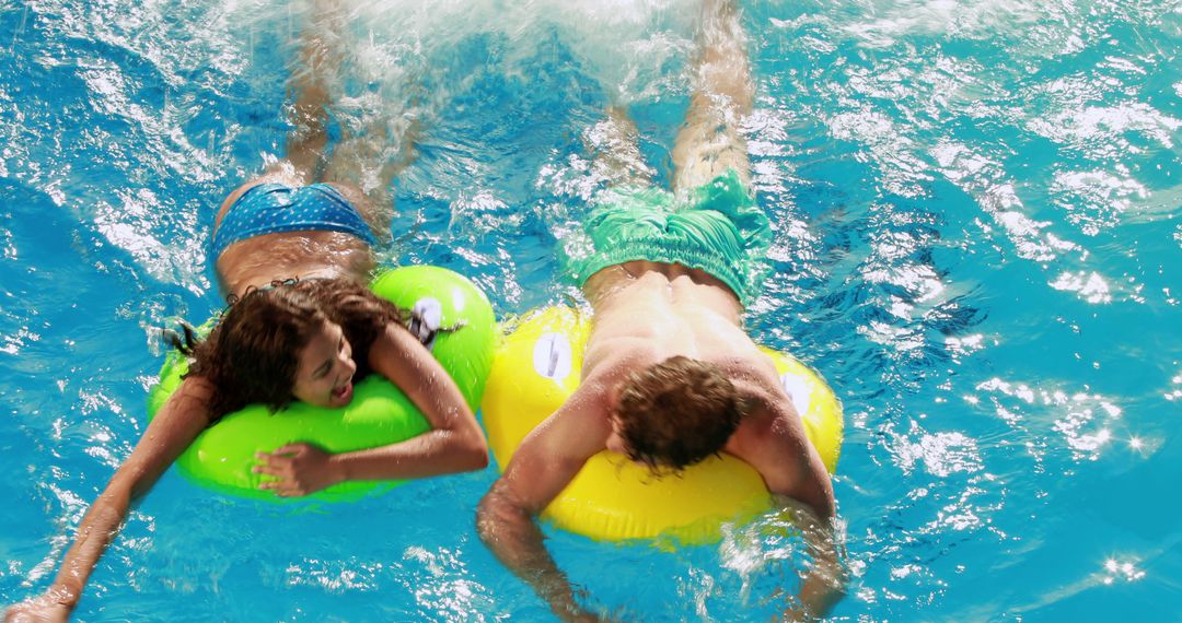 Couple Relaxing on Inflatable Pool Floats in Refreshing Water - Free Images, Stock Photos and Pictures on Pikwizard.com