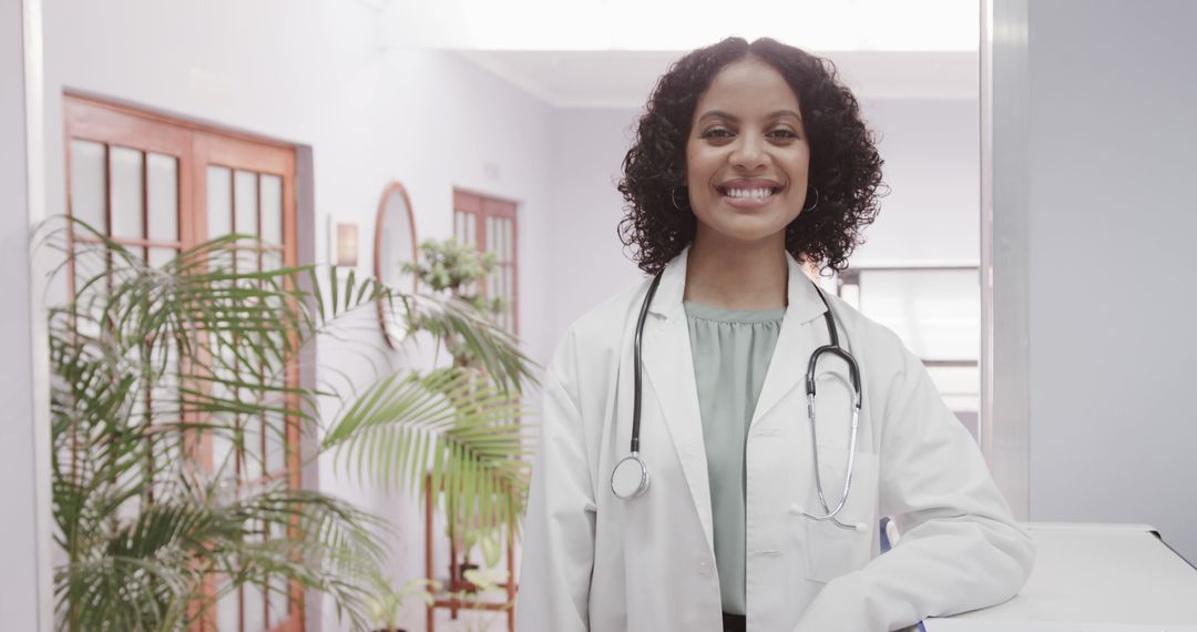 Confident Female Doctor Smiling in Clinical Environment - Free Images, Stock Photos and Pictures on Pikwizard.com