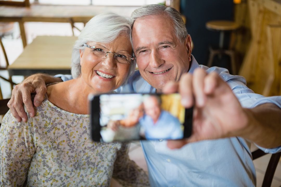 Happy Senior Couple Taking Selfie in Cafe - Free Images, Stock Photos and Pictures on Pikwizard.com