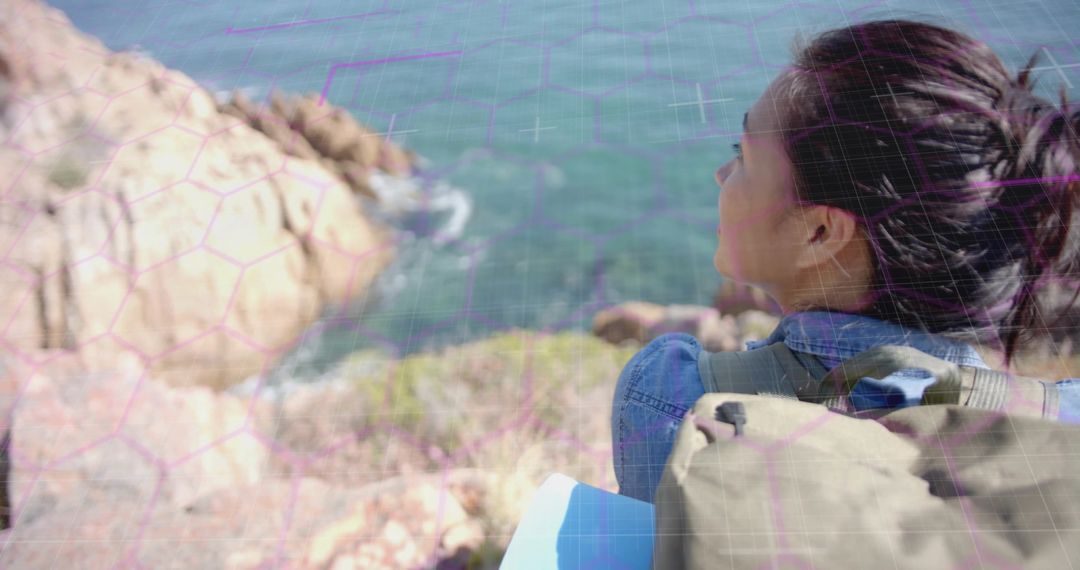 Asian Hiker Exploring Sea Cliffs with Map and Backpack