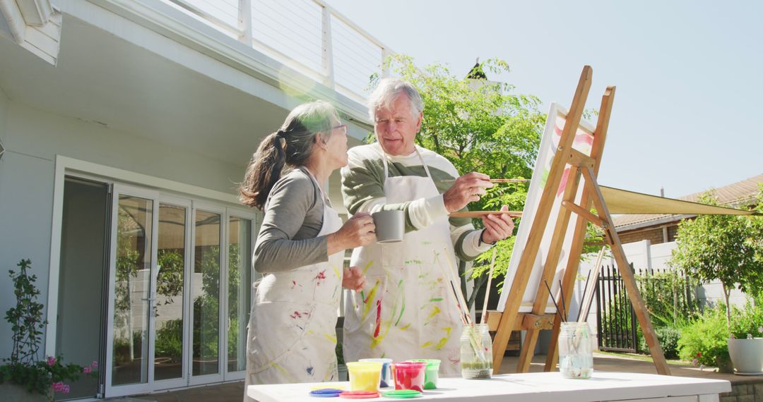 Senior couple engaging in outdoor painting activity - Free Images, Stock Photos and Pictures on Pikwizard.com