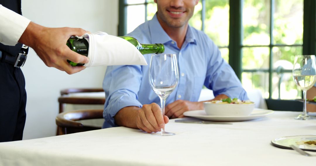 Waiter Pouring Wine for a Happy Customer in a Restaurant - Free Images, Stock Photos and Pictures on Pikwizard.com