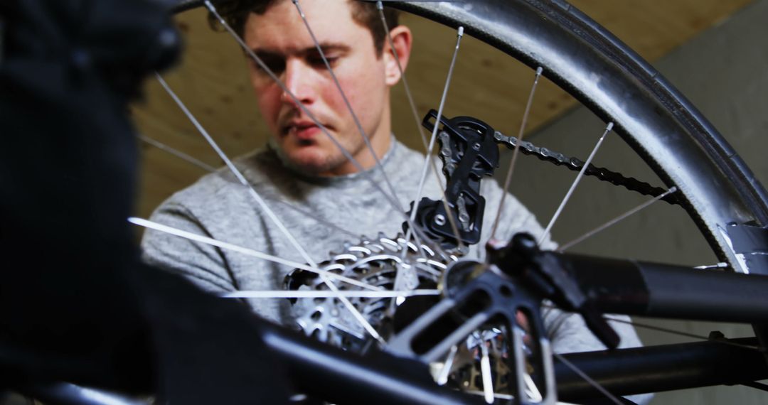 Focused Bicycle Mechanic Repairing Bike Wheel Gear System - Free Images, Stock Photos and Pictures on Pikwizard.com