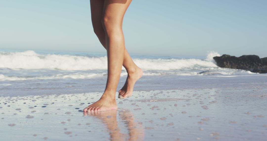 Closeup of Legs Walking Barefoot on Beach with Calm Waves - Free Images, Stock Photos and Pictures on Pikwizard.com