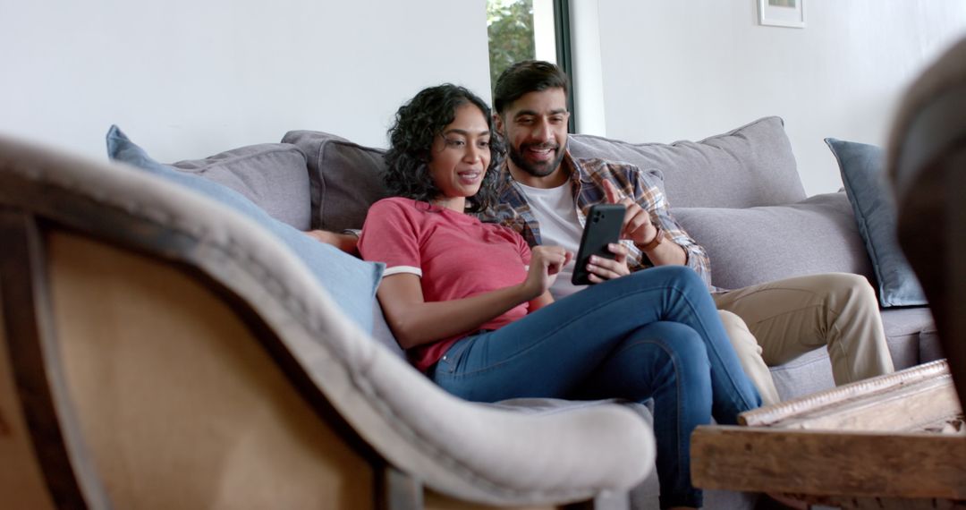 Couple Relaxing Together at Home Sharing Smartphone