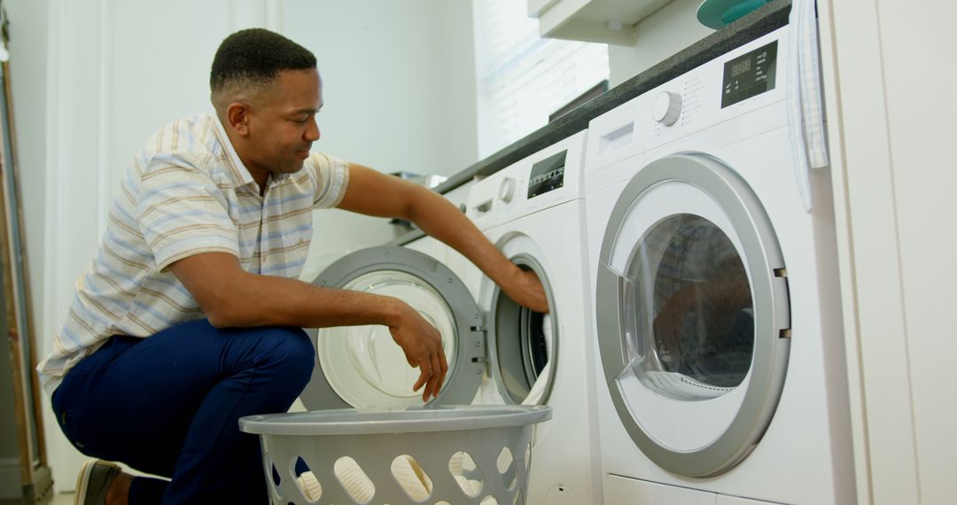 Man Doing Laundry at Home with Washing Machine - Free Images, Stock Photos and Pictures on Pikwizard.com