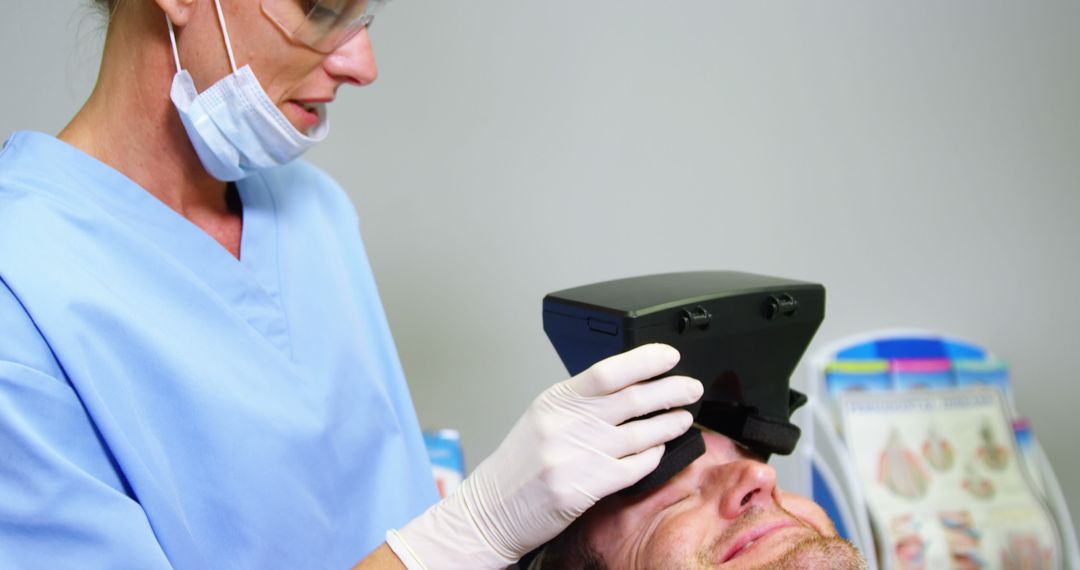 Dentist Examining Patient with Advanced Equipment in Surgical Mask - Free Images, Stock Photos and Pictures on Pikwizard.com