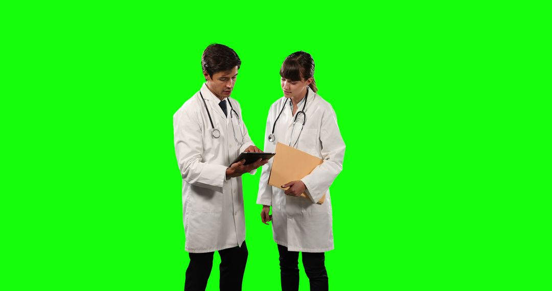 Two Doctors Discussing Patient Records on Tablet with Green Screen Background - Free Images, Stock Photos and Pictures on Pikwizard.com