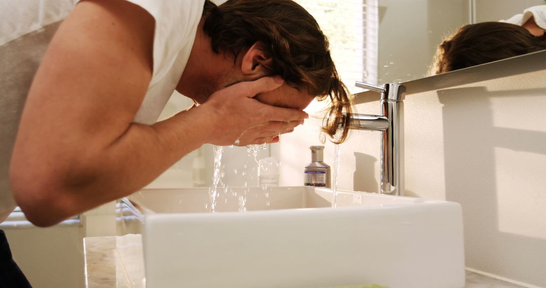 Man Washing Face in Home Bathroom Morning Routine - Free Images, Stock Photos and Pictures on Pikwizard.com