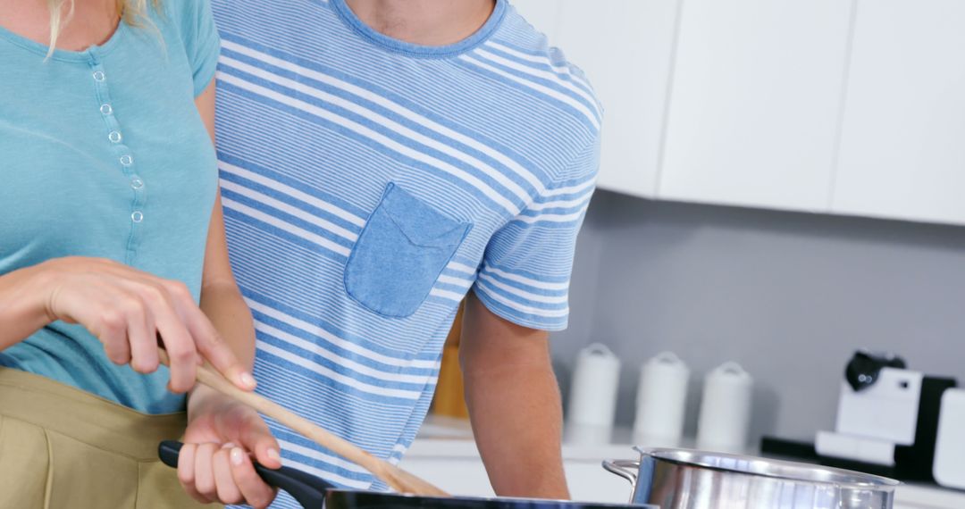 Young couple cooking in modern home kitchen together
