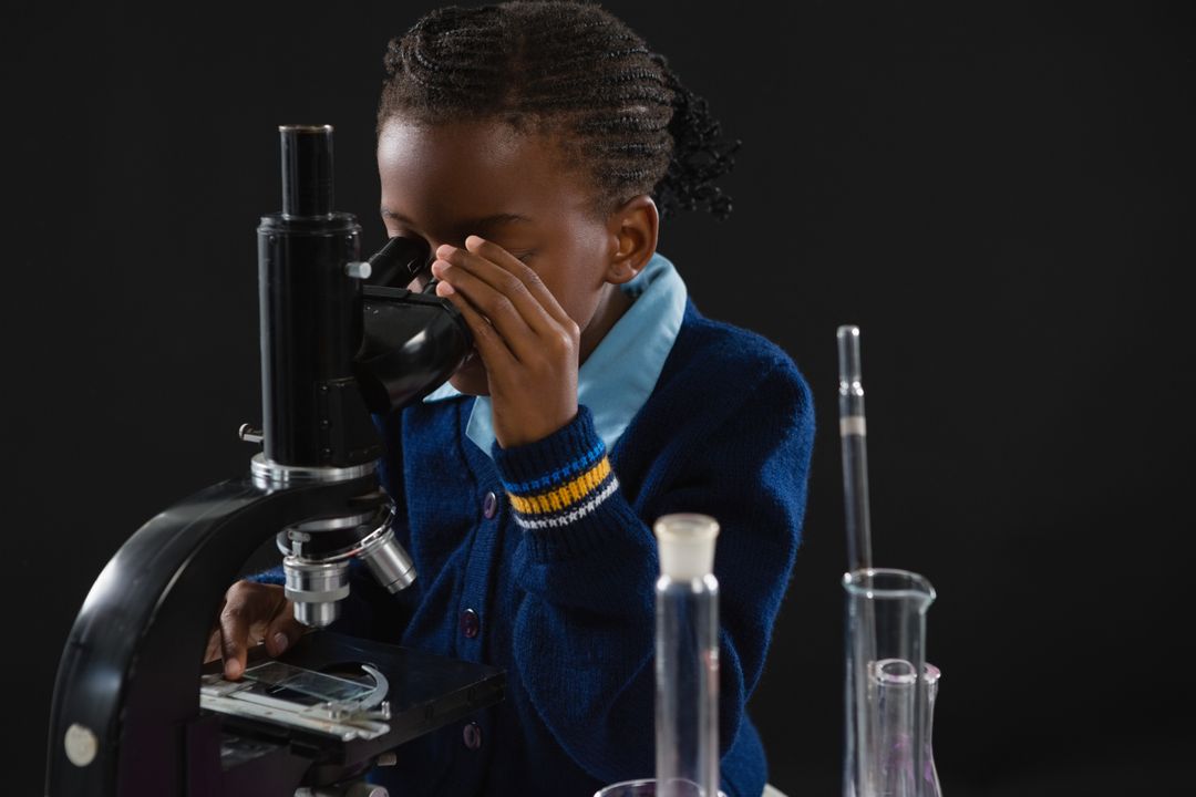 Schoolgirl using microscope - Free Images, Stock Photos and Pictures on Pikwizard.com