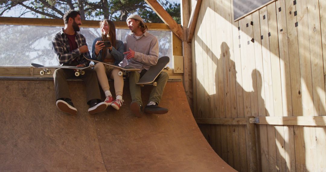 Group of Friends Relaxing on Skate Ramp with Tablets - Free Images, Stock Photos and Pictures on Pikwizard.com