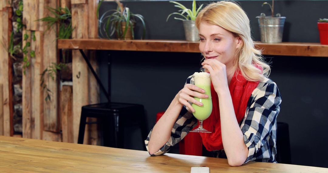 Woman Enjoying Green Smoothie in Rustic Cafe - Free Images, Stock Photos and Pictures on Pikwizard.com