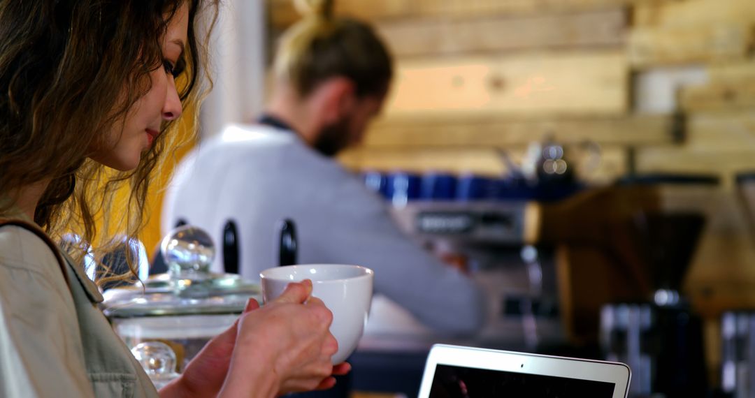 Woman Enjoying Coffee and Watching Video in Cozy Cafe - Free Images, Stock Photos and Pictures on Pikwizard.com