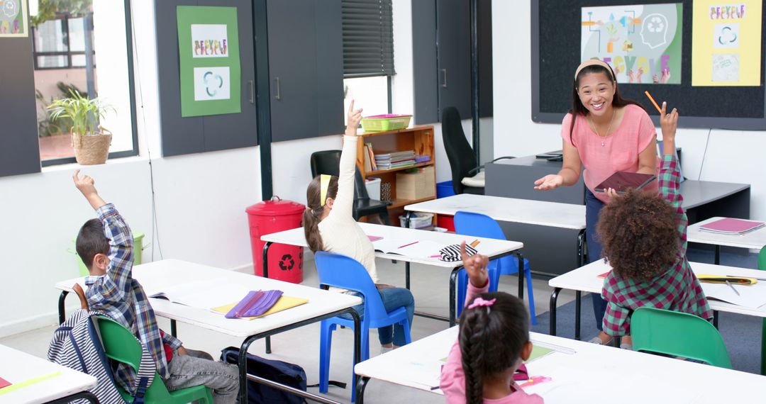 Engaged Teacher Interacting with Students Raising Hands in Classroom