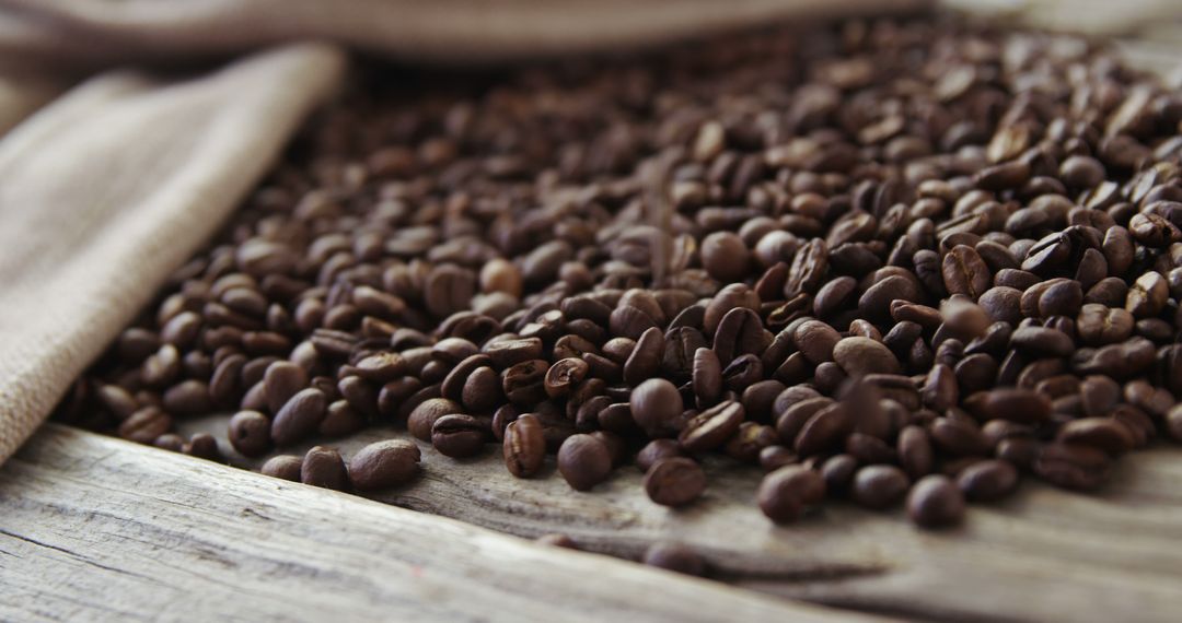 Close-up of Roasted Coffee Beans on Rustic Wooden Table - Free Images, Stock Photos and Pictures on Pikwizard.com