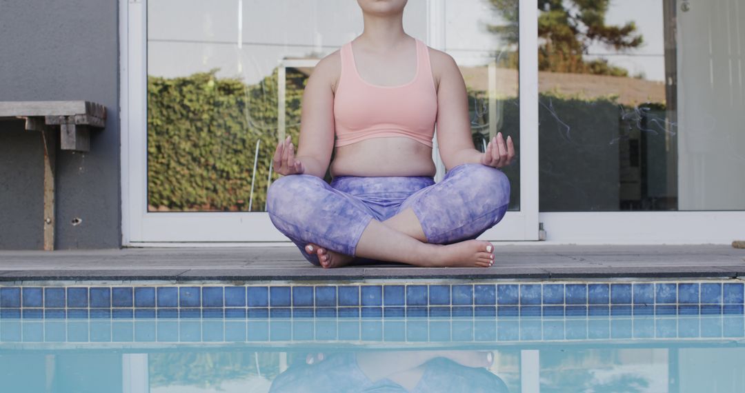 Woman Meditating by Swimming Pool in Serene Setting - Free Images, Stock Photos and Pictures on Pikwizard.com