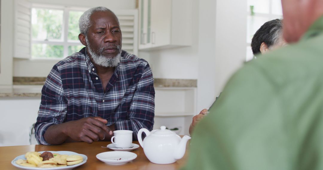 Senior Man Having Tea with Friends at Home - Free Images, Stock Photos and Pictures on Pikwizard.com