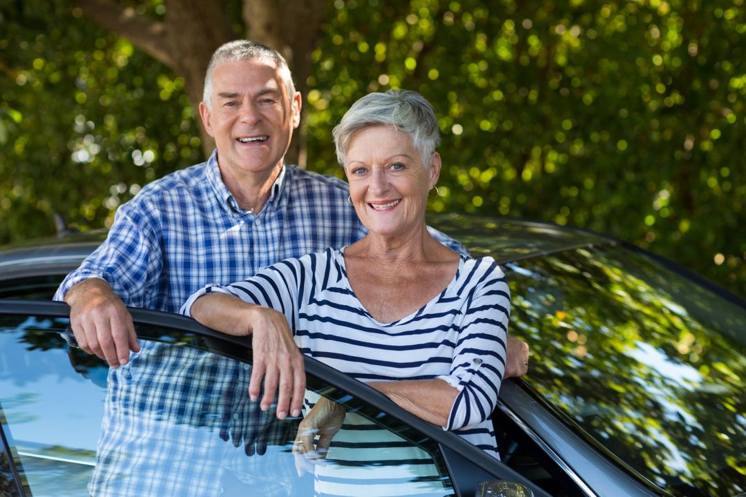 Smiling senior couple leaning on car door - Free Images, Stock Photos and Pictures on Pikwizard.com