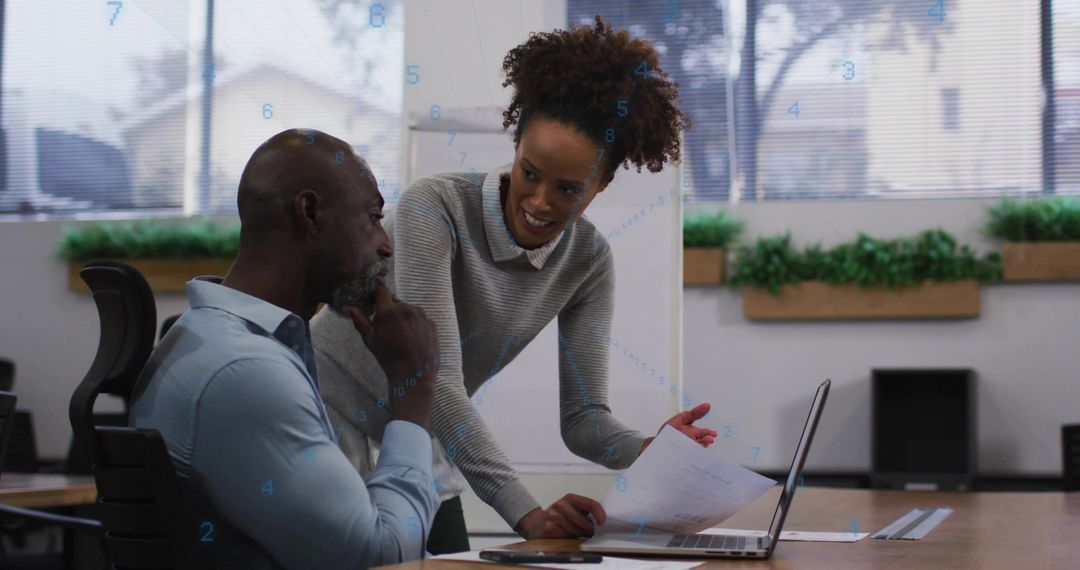 Co-Workers Discussing Information at Modern Office Setting