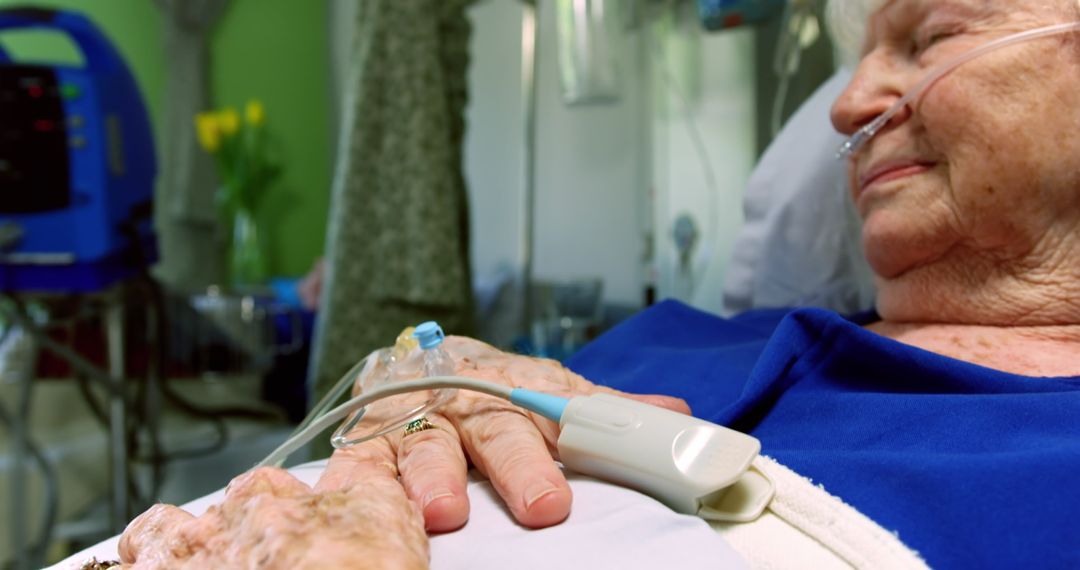 Elderly Patient Resting on Hospital Bed with Medical Equipment - Free Images, Stock Photos and Pictures on Pikwizard.com