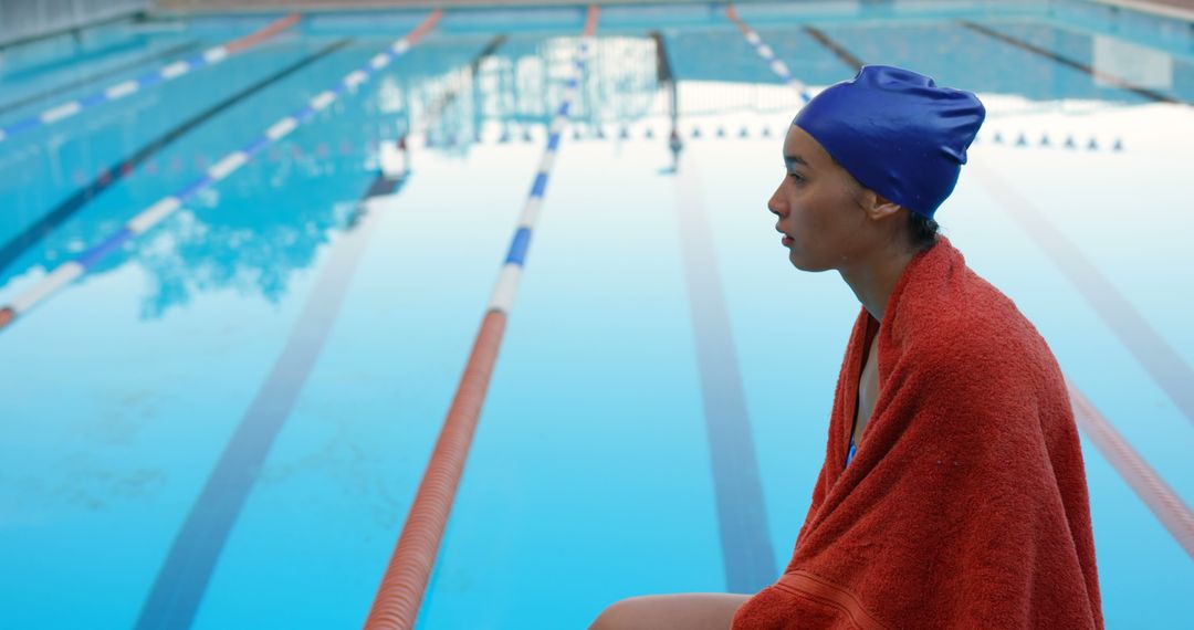 Young Female Swimmer Wrapped in Towel by Poolside - Free Images, Stock Photos and Pictures on Pikwizard.com