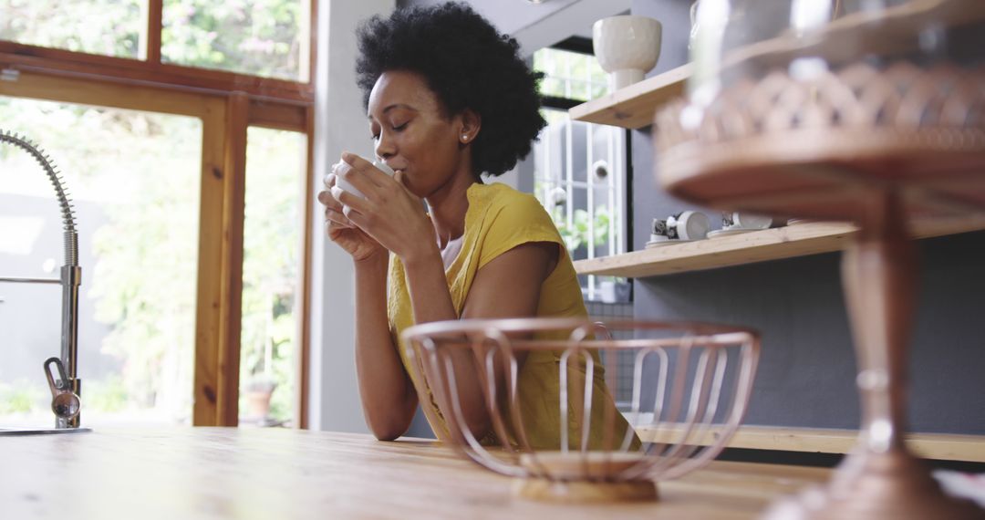 Woman Drinking Coffee in Modern Kitchen with Natural Light - Free Images, Stock Photos and Pictures on Pikwizard.com