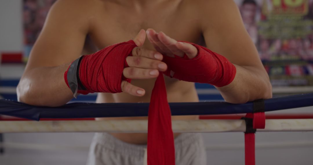 Boxer Preparing Wrapping Hands with Red Boxing Wraps - Free Images, Stock Photos and Pictures on Pikwizard.com