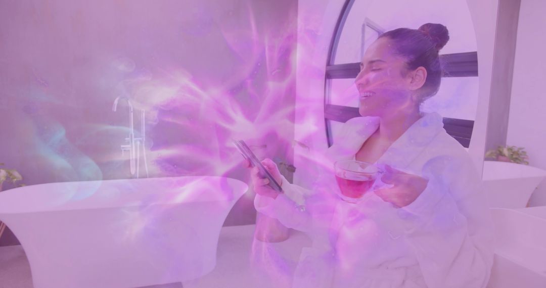 Woman in Bathrobe Enjoying Tea and Smartphone in Modern Spa