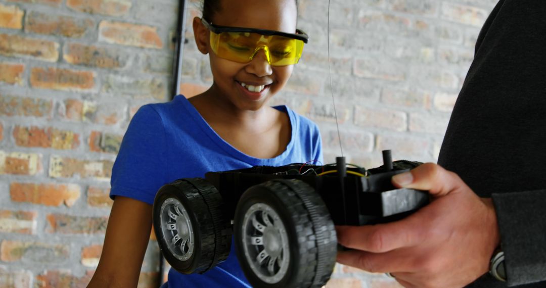 Young Girl Engaged in STEM Activity with Robotic Car - Free Images, Stock Photos and Pictures on Pikwizard.com