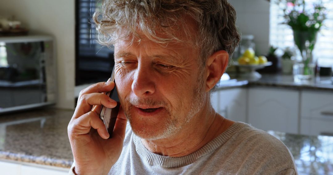 Senior Man Talking on Mobile Phone in Kitchen Enjoying Conversation - Free Images, Stock Photos and Pictures on Pikwizard.com