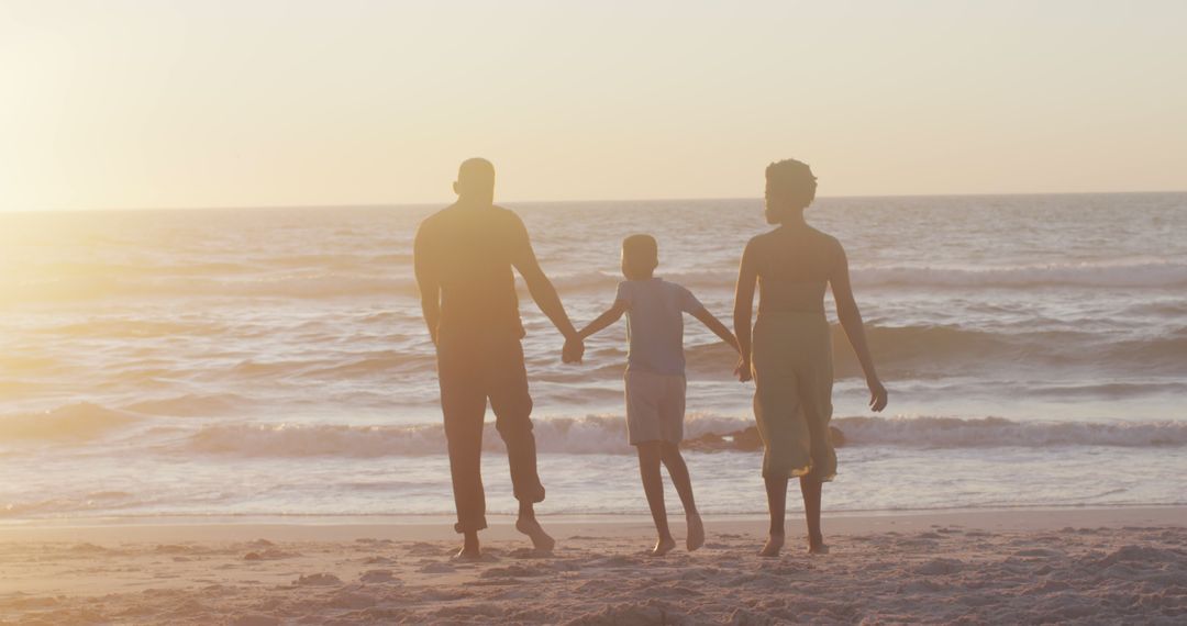 Family Holding Hands Walking on Beach at Sunset - Free Images, Stock Photos and Pictures on Pikwizard.com