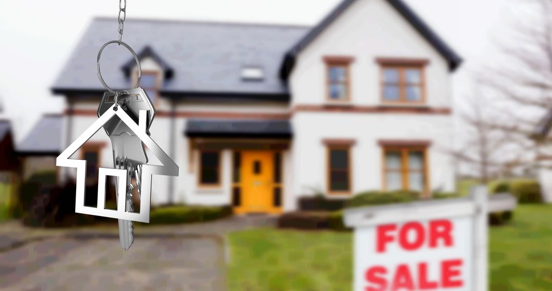 Silver House Key Fob with Blurred Home Background