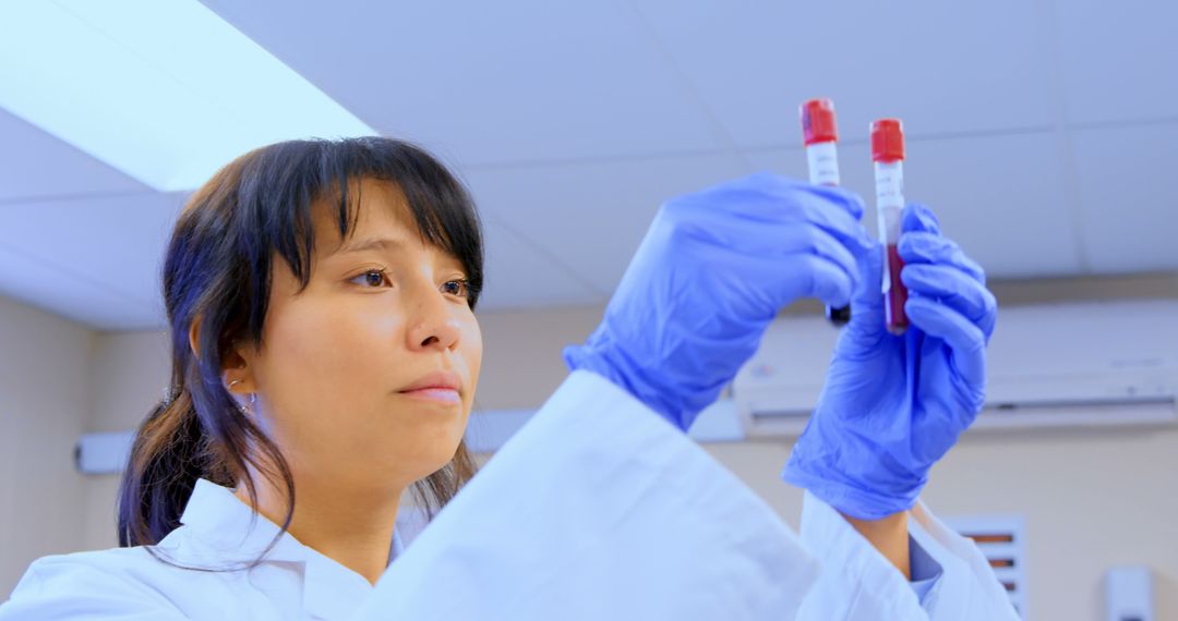 Female Scientist Examining Blood Samples in a Laboratory - Free Images, Stock Photos and Pictures on Pikwizard.com