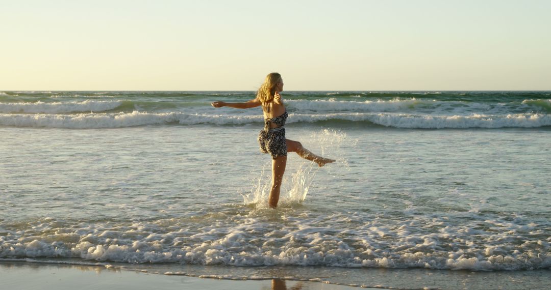 Woman Dancing in Ocean Waves at Sunset - Free Images, Stock Photos and Pictures on Pikwizard.com