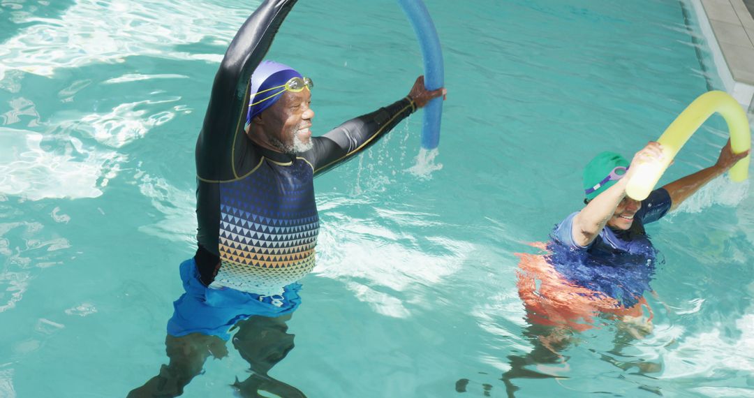 Senior Couple Enjoying Water Aerobics Class in Indoor Pool - Free Images, Stock Photos and Pictures on Pikwizard.com