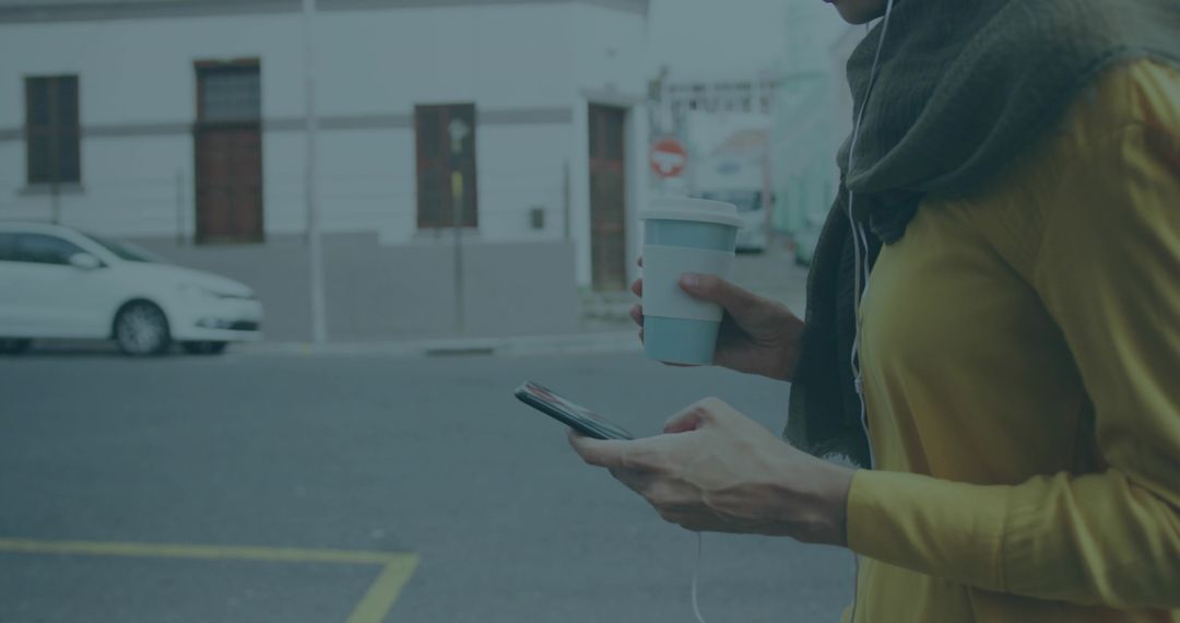 Woman Enjoying Coffee While Using Smartphone on Urban Street