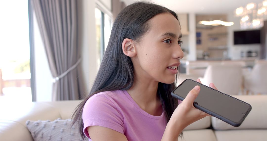 Teen Girl Using Voice Assistant on Smartphone at Home