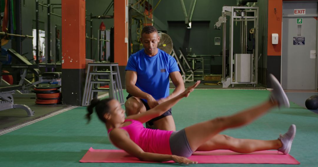 Personal Trainer Assisting Woman with Leg Raise Exercise at Gym - Free Images, Stock Photos and Pictures on Pikwizard.com