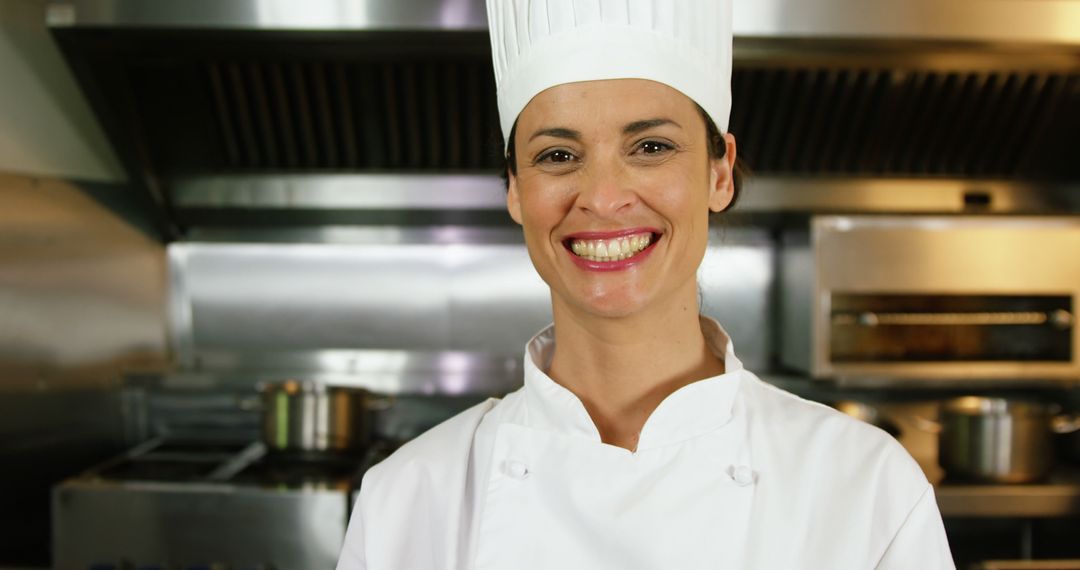 Smiling Woman Chef in Professional Kitchen - Free Images, Stock Photos and Pictures on Pikwizard.com