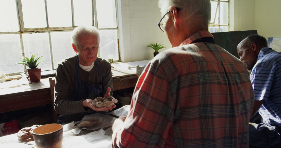 Senior Artisans Engaged in Sculpting Activity in Bright Studio - Free Images, Stock Photos and Pictures on Pikwizard.com