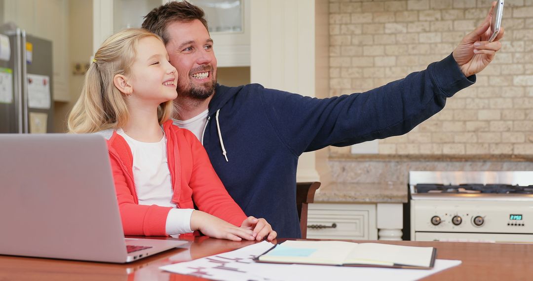 Father and Daughter Taking Selfie in Kitchen - Free Images, Stock Photos and Pictures on Pikwizard.com