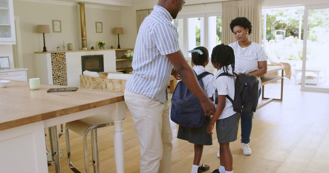 Parents Helping Children with Backpacks Before School