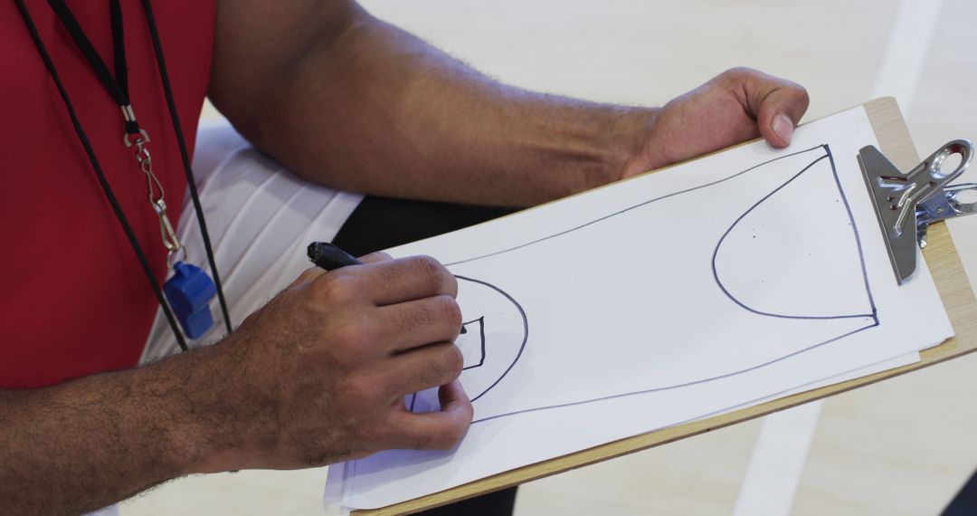 Coach Drawing Basketball Play on Clipboard During Practice - Free Images, Stock Photos and Pictures on Pikwizard.com