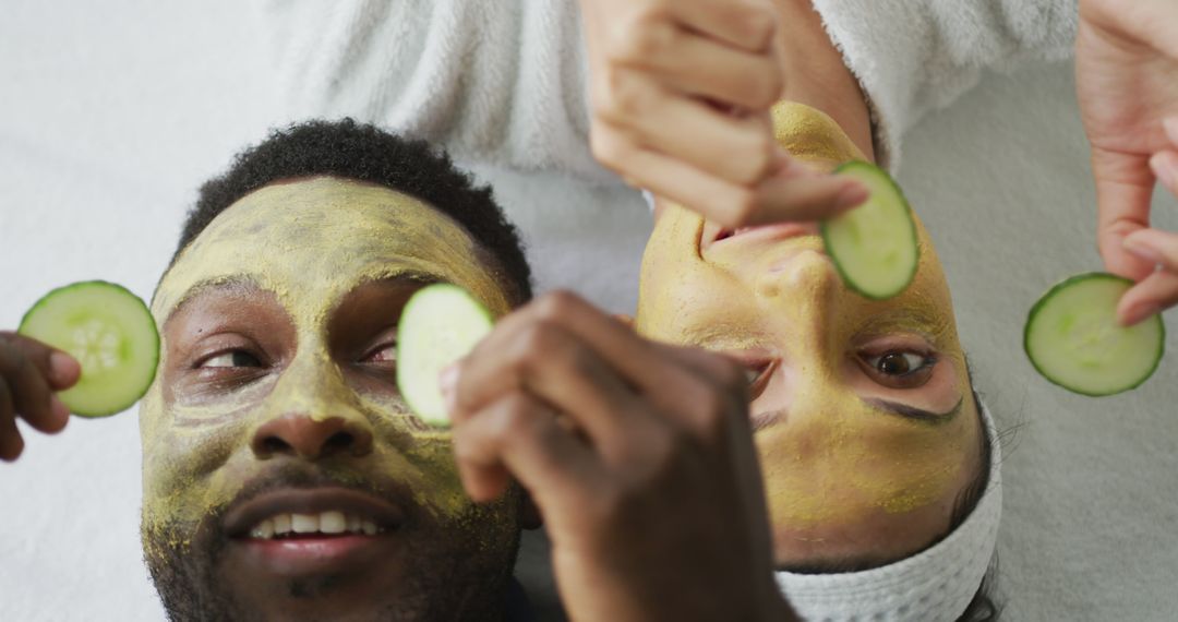 Diverse Couple Relaxed with Face Masks and Cucumber Slices at Home Spa