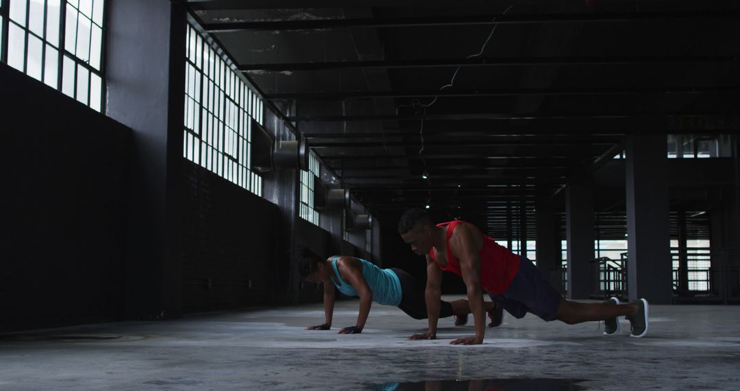 Two Diverse People Exercising in Urban Industrial Gym - Free Images, Stock Photos and Pictures on Pikwizard.com